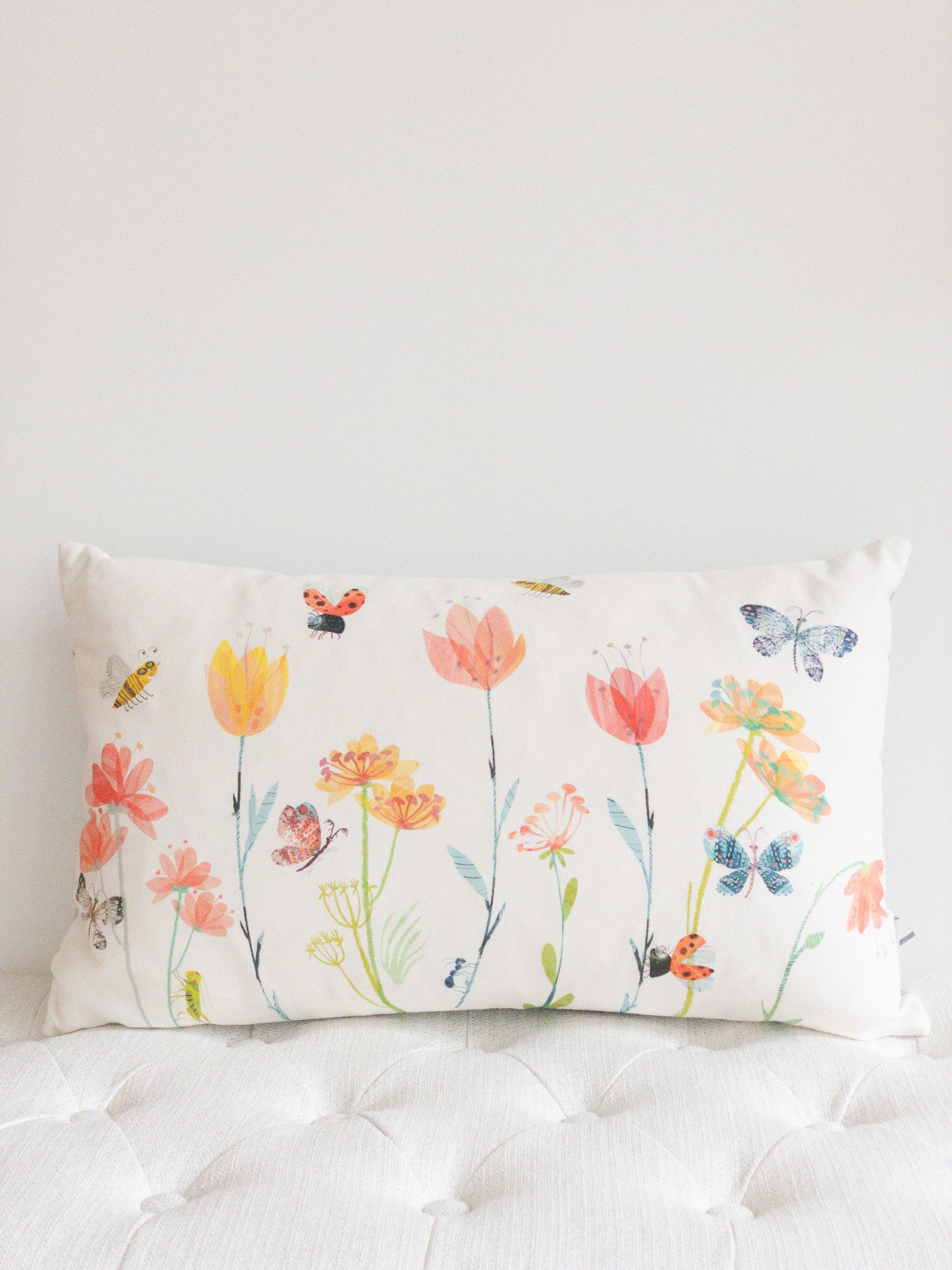 White lumbar designer pillow with insects and flower motif.  Spring decor throw pillow.