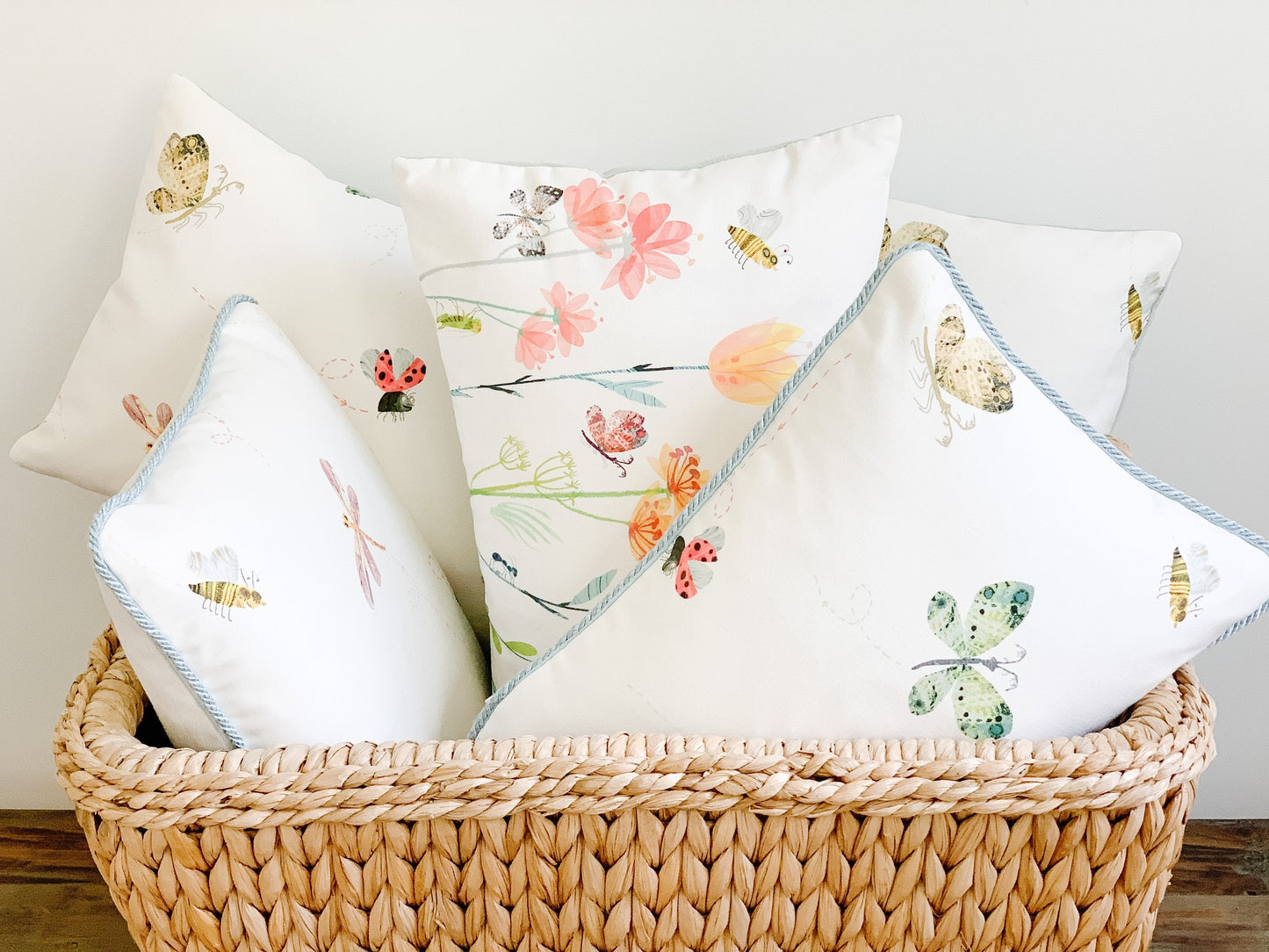 Basket of small lumbar decorative pillows with butterfly motif