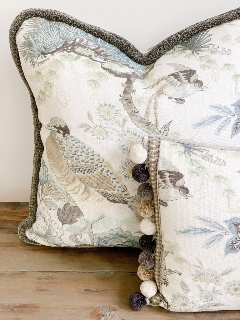 Designer pillow with floral motif and decorative trim