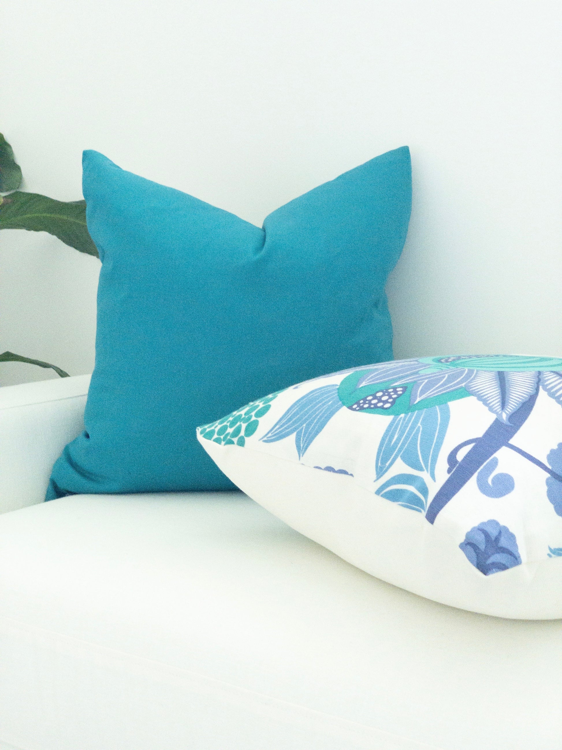 Peacock blue solid pillow with printed coordinating decorative pillow
