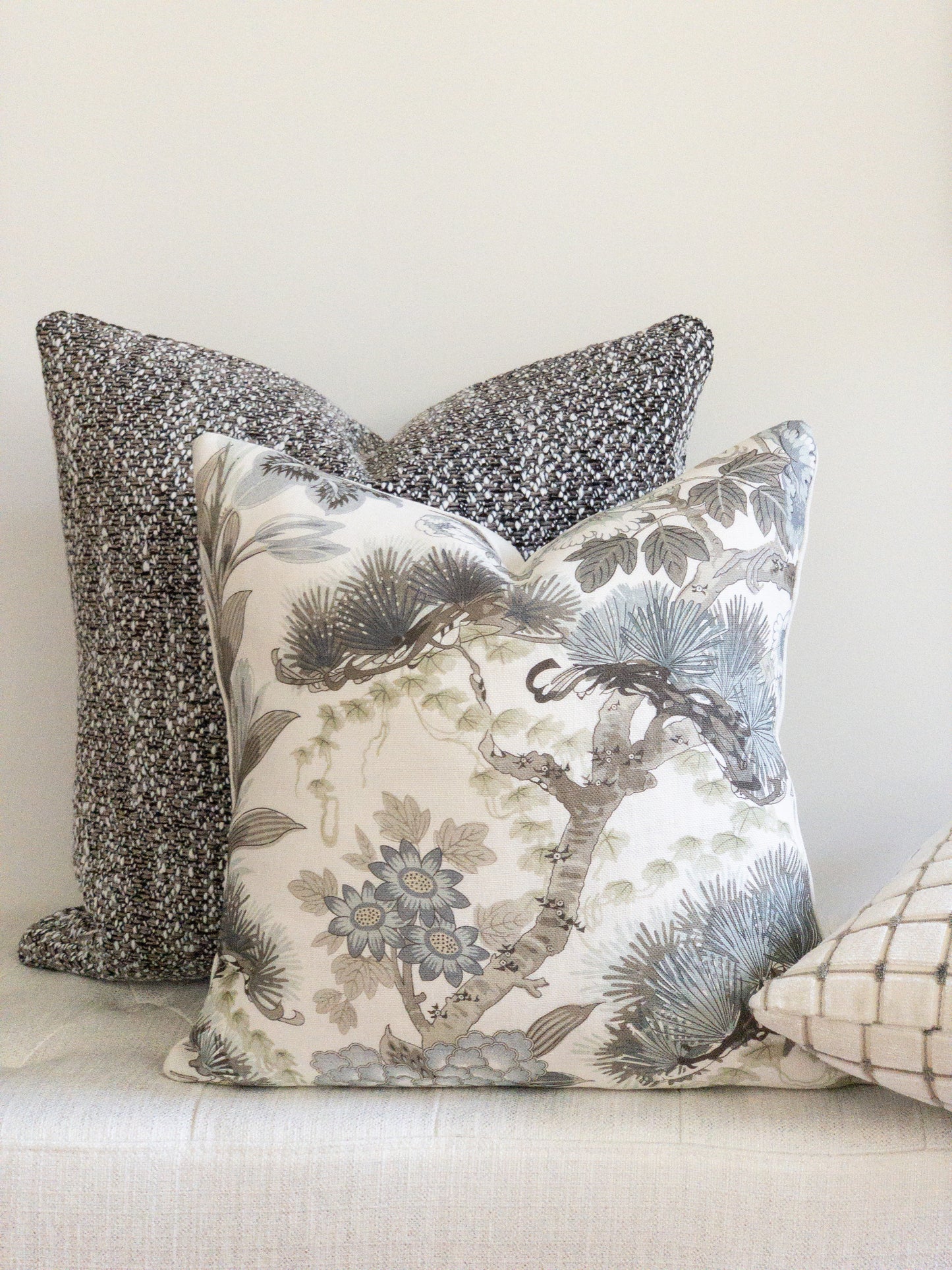 Blue and white floral accent pillow with brown and white boucle designer pillow