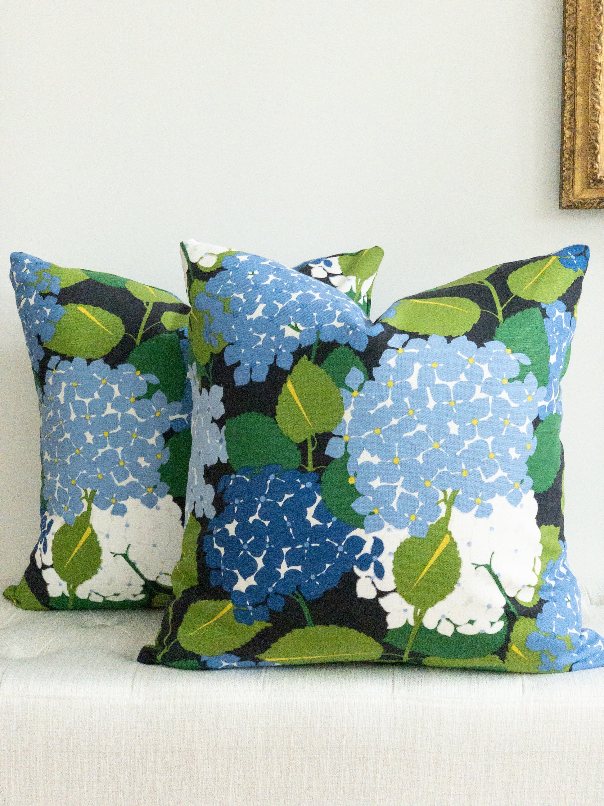 Square designer pillow with large blue and purple hydrangea on a black backgoround le \
