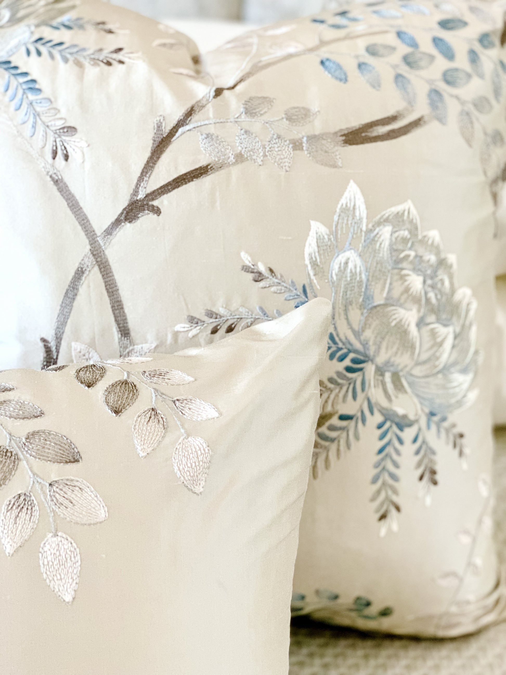 Closeup of silver and blue silk floral pillow