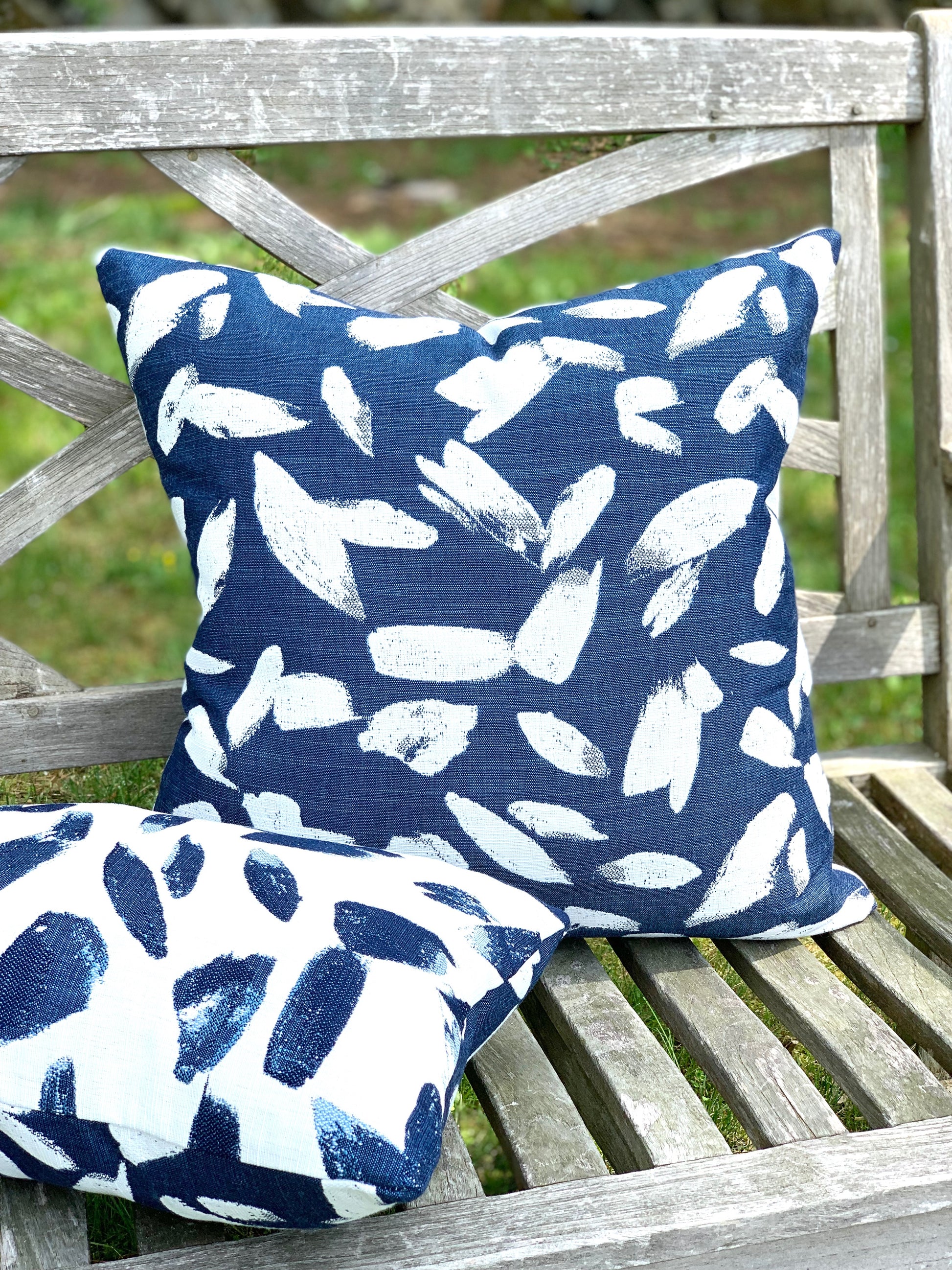 Blue and white outdoor designer pillow with reversible fabric by Perennials